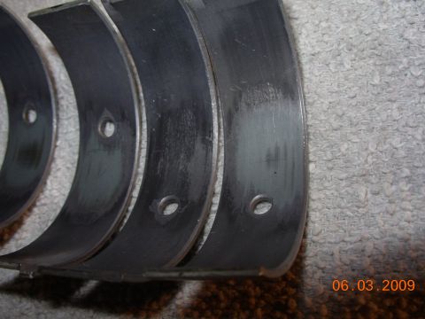 1995 Ford Taurus - Worn engine bearings with visible scoring and wear marks. A date stamp indicates the photo was taken on March 6, 2009.