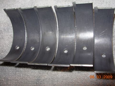 1995 Ford Taurus - Engine bearings shown laid out on a textured gray surface.