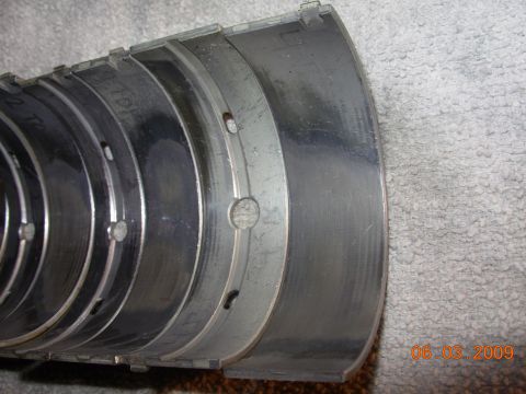 1995 Ford Taurus - Close-up view of engine bearings, showing wear patterns and lubrication holes.