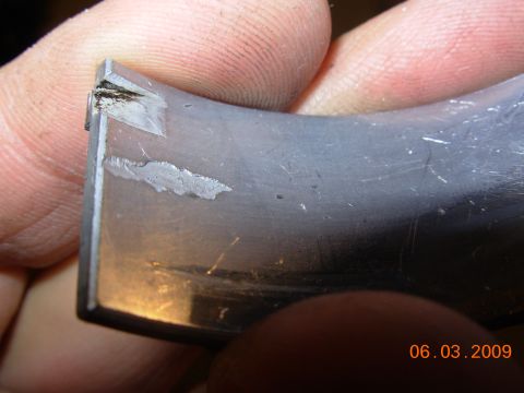 1995 Ford Taurus - This engine bearing shows significant wear and damage, indicating a potential mechanical issue.