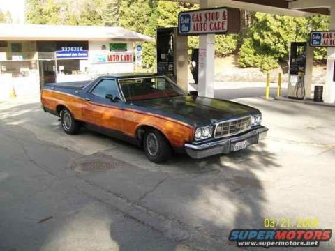1973 Ford Ranchero - This 1973 Ford Ranchero pickup features distinctive wood paneling and is seen parked at a gas stop and auto care facility.
