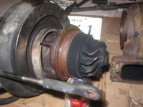 1989 Ford Bronco - A turbocharger part is shown in detail, with a license plate in the background.
