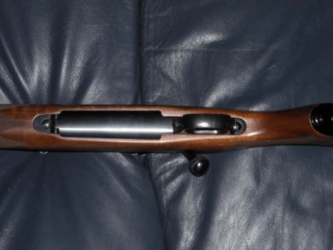 1991 Ford Bronco - The action and wooden stock of a rifle are shown in detail against a dark background.