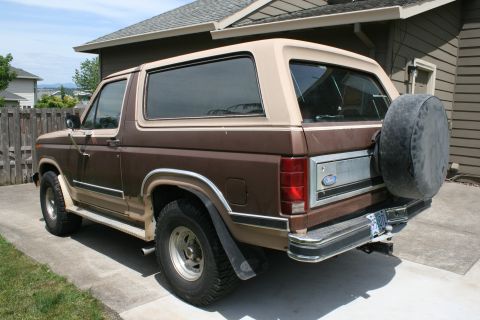 1984 Ford Bronco - This 1984 Ford Bronco is shown in a rear 3/4 view, its distinctive two-tone brown paint and external spare tire.