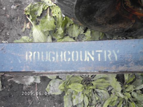 1986 Ford Bronco - A close-up view of a blue suspension component with the "ROUGHCOUNTRY" brand name visible.