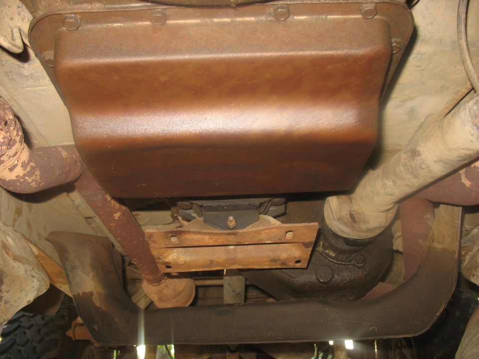 Underside view of vehicle transmission pan and exhaust pipes