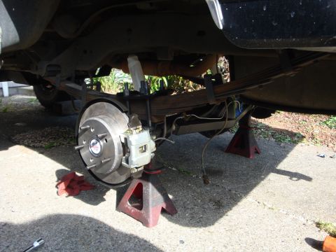 1989 Ford Bronco - Rear suspension and brake work in progress on a vehicle.
