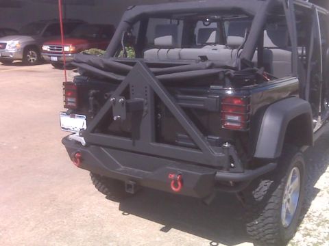 2008 Jeep Wrangler - Rear view of a Jeep Wrangler with an aftermarket bumper and spare tire carrier installed.