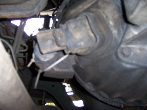 1991 Ford Bronco - Close-up view of the vehicle's undercarriage, focusing on mechanical parts.