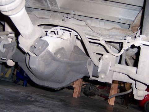 1991 Ford Bronco - The underside of a vehicle is shown, focusing on the rear differential and suspension parts.