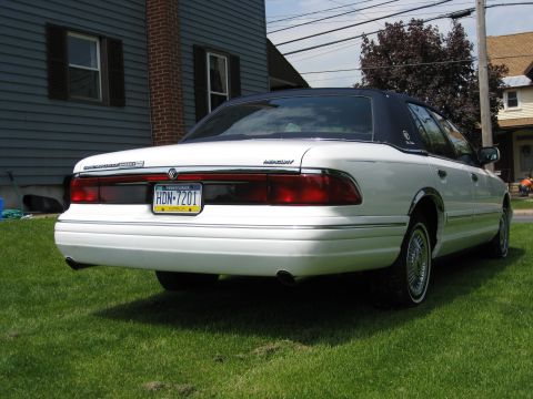 1996 Mercury Grand Marquis - Rear view of a white 1996 Mercury Grand Marquis with a dark vinyl roof.