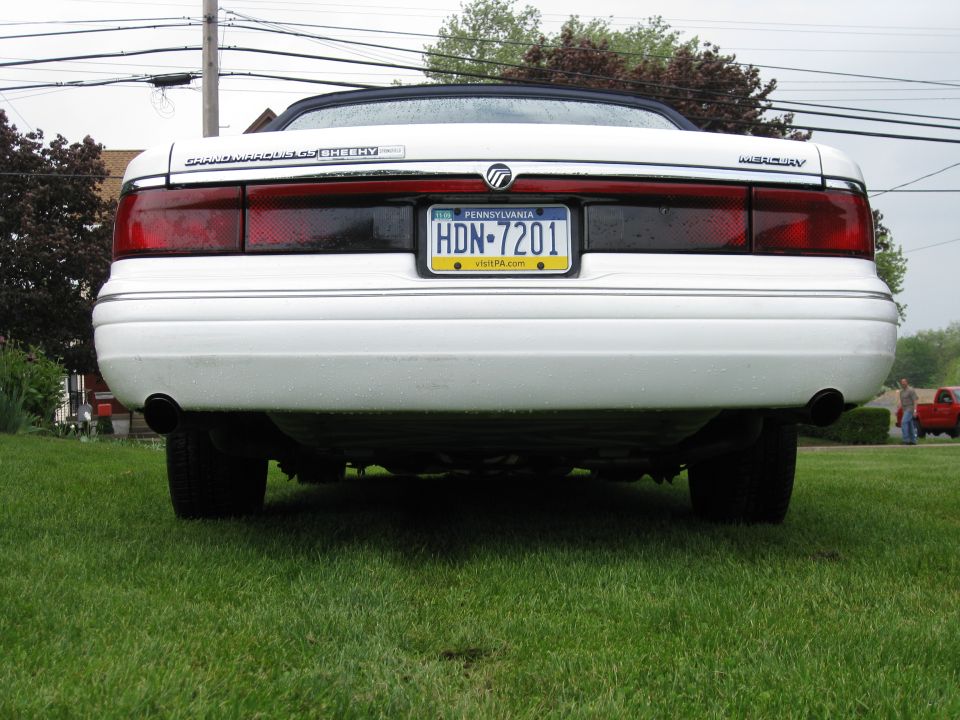 Rear view of a white 1996 Mercury Grand Marquis convertible with a black top and Pennsylvania plates