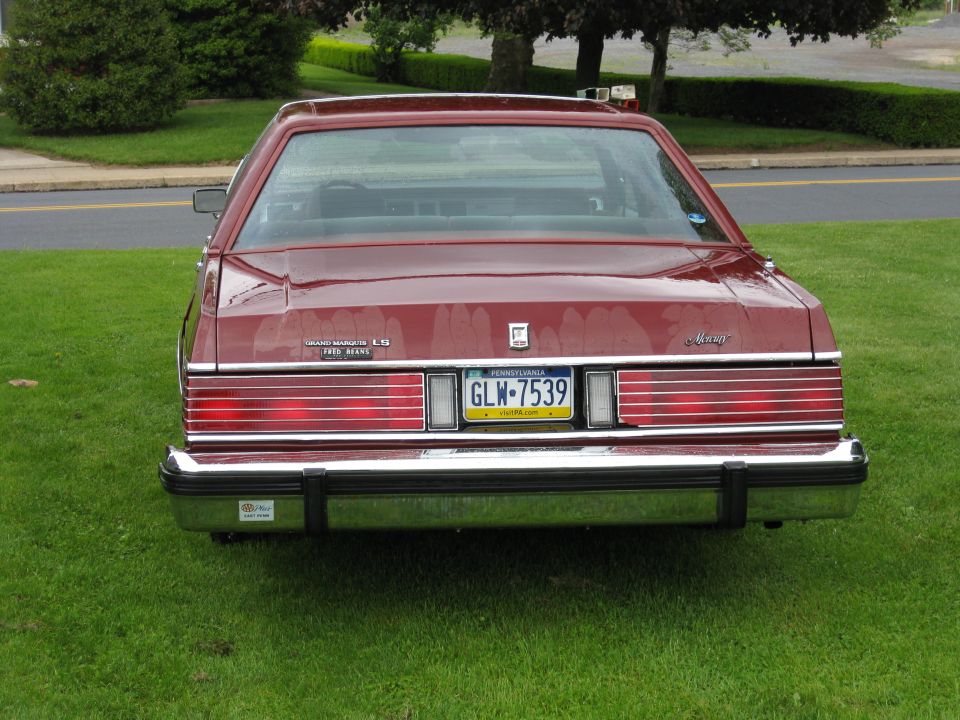 Rear of maroon Mercury Grand Marquis LS sedan on grass with Pennsylvania plate GLW-7539