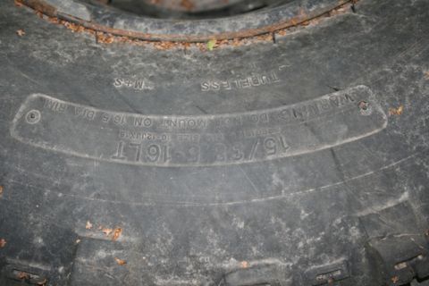 1990 Chevrolet Suburban - Close-up of a tire's sidewall reveals its size as 15/38-16LT and indicates it is tubeless.