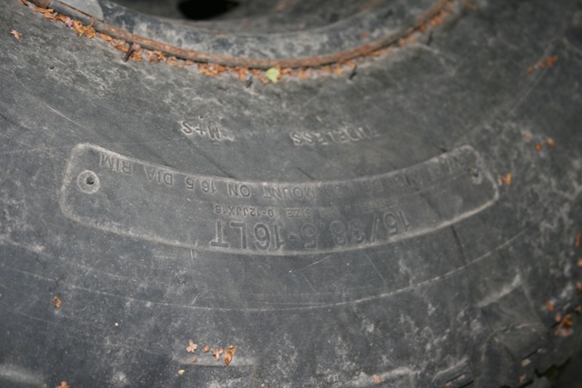 Close-up of tire sidewall showing size 15/38-16LT and mount on 16.5 dia rim