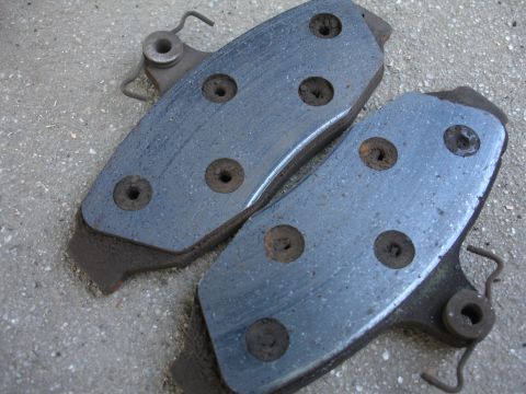 1990 Ford Taurus - These brake pads show signs of wear and are ready for replacement.