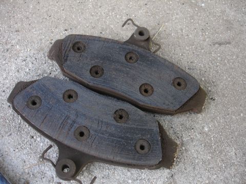 1990 Ford Taurus - Close-up view of worn brake pads, showing the friction material and metal components.