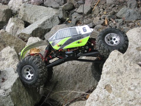 2010 Ford Pickup - An RC rock crawler navigates a rocky terrain, its suspension and off-road tires.