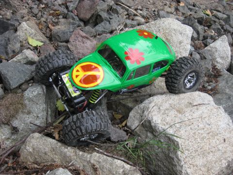 2010 Ford Pickup - A remote control car designed to look like a classic Volkswagen Beetle is shown navigating a rocky terrain.