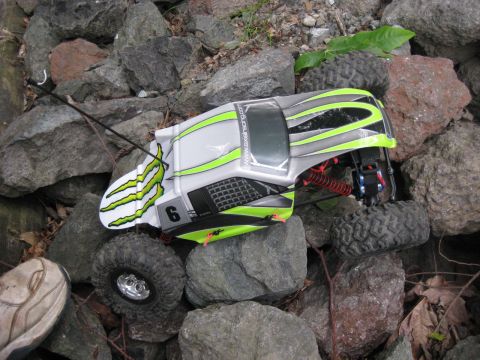2010 Ford Pickup - A remote-controlled rock crawler is positioned on a pile of large stones.