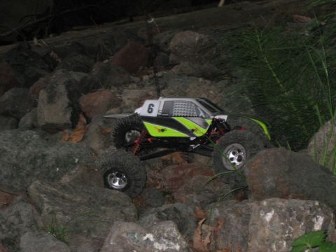 2010 Ford Pickup - A remote control rock crawler is shown traversing a rocky terrain at night.