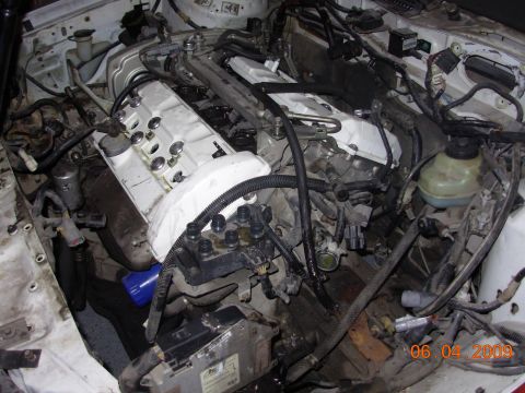1995 Ford Taurus - Close-up view of a disassembled engine bay, showing internal components and wiring.