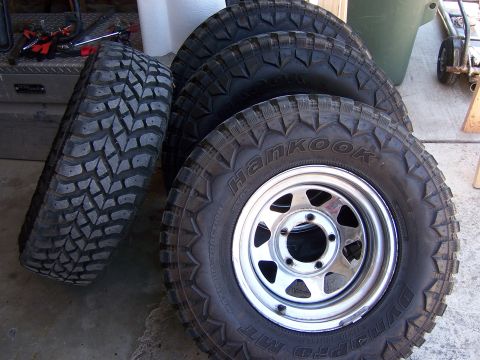 1991 Ford Bronco - A set of four Hankook Dynapro MT off-road tires are displayed, with one tire leaning against the others.