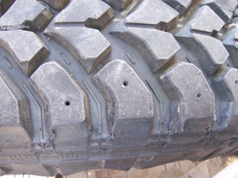 1991 Ford Bronco - The aggressive tread pattern on this off-road tire is designed for maximum traction in challenging terrain.
