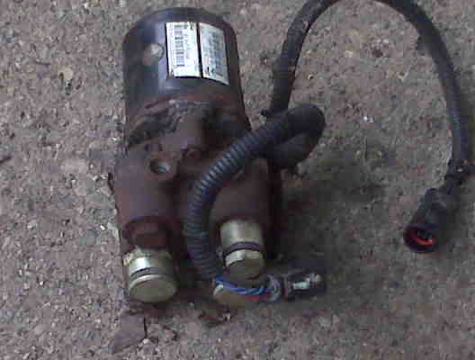 Automotive part with labels and wiring harness on gravel