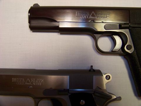 1995 Mercury Grand Marquis - Two Colt Delta Elite pistols are displayed, highlighting their slide markings and overall design.
