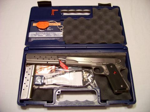 1995 Mercury Grand Marquis - A Colt 1911 pistol and accessories are displayed in a blue carrying case.