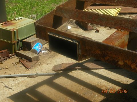 1991 Ford F-150 - A close-up view of a rusted metal frame, possibly part of a trailer, with various debris scattered around.