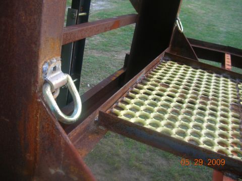 1991 Ford F-150 - Close-up of a trailer's structural components, including a tie-down point and a grated step.