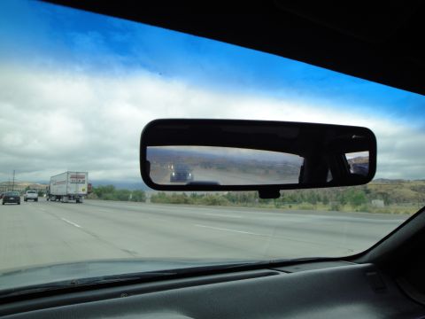 1990 Ford Taurus - View from inside a car on a highway, with a truck and other vehicles visible on the road ahead.