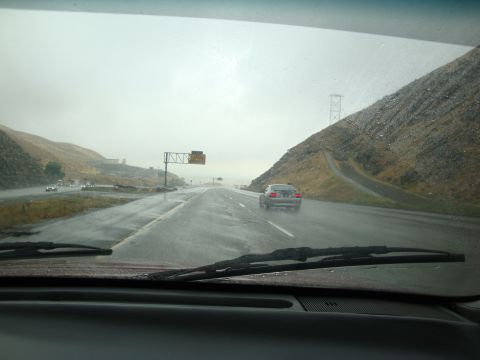 1990 Ford Taurus - Driving on a rainy highway with limited visibility and wet road conditions.