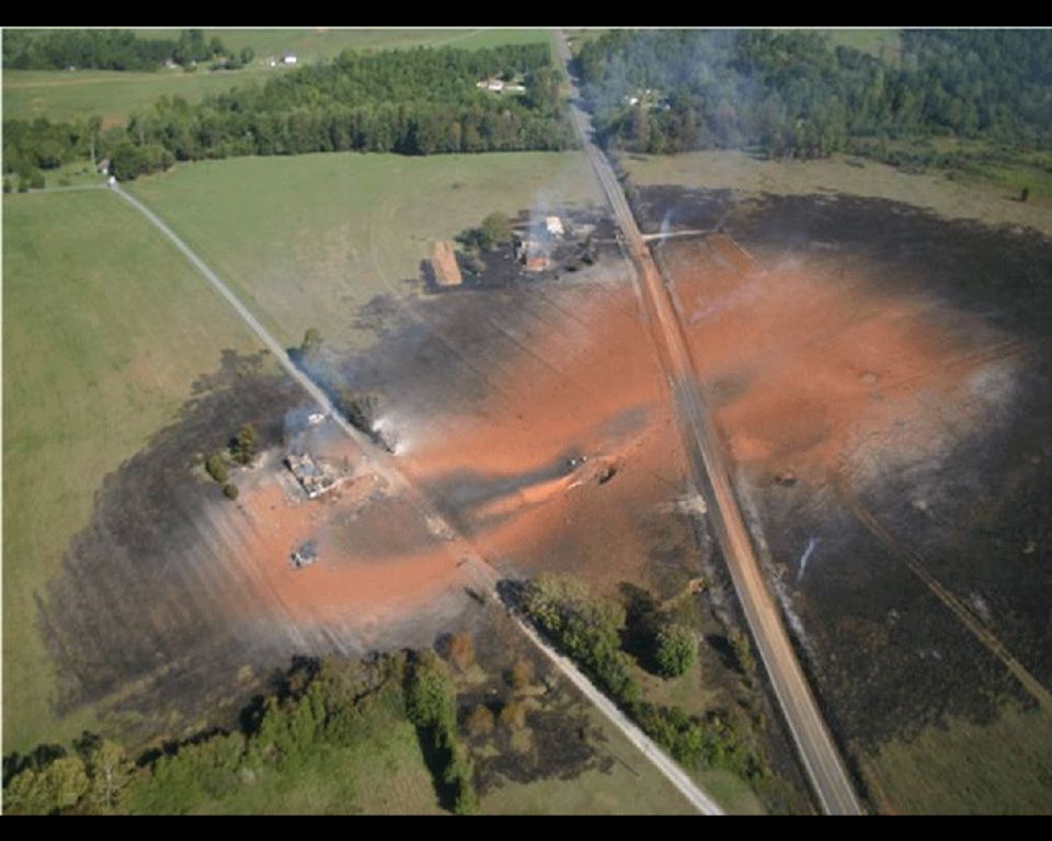 overhead shot of a field with a big orange patch, looks like a spill or burn