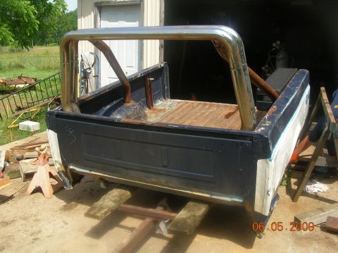 1991 Ford F-150 - A truck bed with a roll bar is shown, supported by jack stands in an outdoor setting.