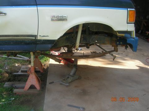 1991 Ford F-150 - Front suspension of a 1991 Ford F-150 is disassembled and supported by jack stands for repair.