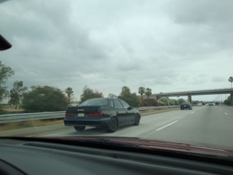 1990 Ford Taurus - Driving on the highway with a 1990 Ford Taurus in view.