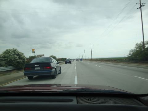 1990 Ford Taurus - Driving on a highway with a 1990 Ford Taurus SHO in the left lane.