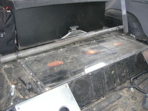1996 Ford Bronco - Vehicle interior showing custom audio installation with multiple amplifiers under a clear cover.