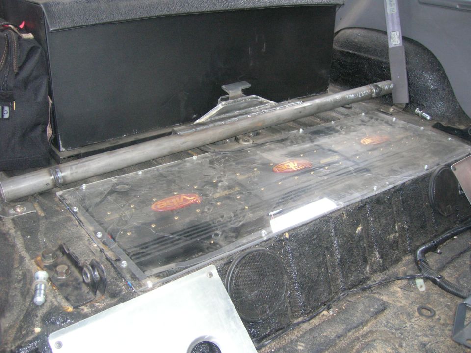 Custom subwoofer box with Vibe amplifiers installed in the rear cargo area of a vehicle. Roll bar visible