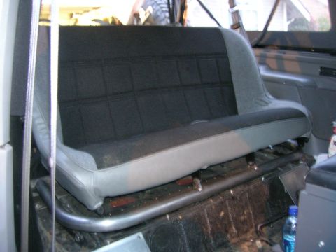 1996 Ford Bronco - Interior view of a vehicle's rear seat and roll bar assembly.