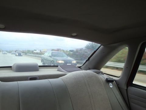 1990 Ford Taurus - Driving on the highway with another car in front.