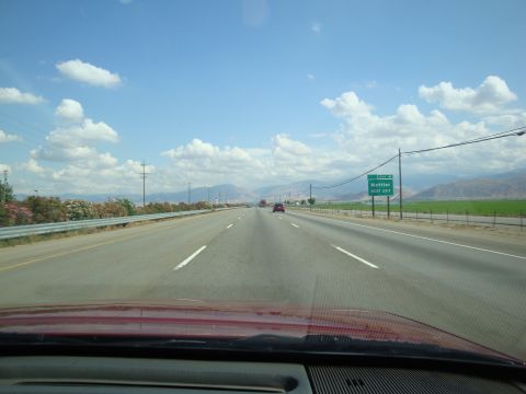 1990 Ford Taurus - Driving on a highway with a sign for Mettler next exit, under a partly cloudy sky.
