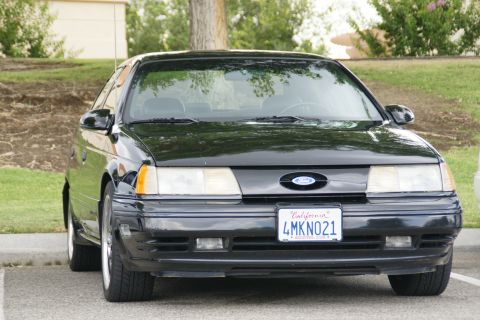 1990 Ford Taurus - Front view of a black 1990 Ford Taurus with a California license plate.