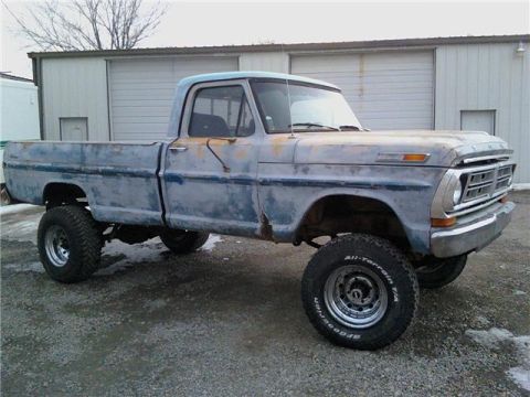 1971 Ford F-100 - This 1971 Ford F-100 pickup truck features a lifted suspension and a weathered blue paint job.