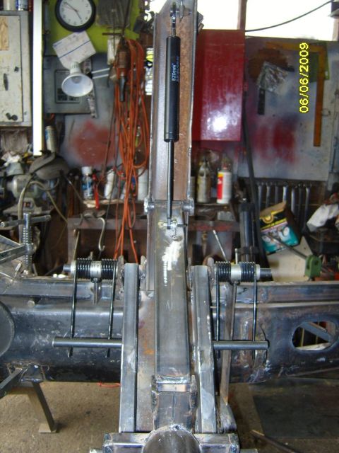 1989 Ford Bronco - Custom suspension part with gas strut and springs, likely for a vehicle modification project.