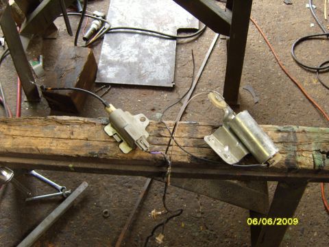 1989 Ford Bronco - Two car door lock actuators and associated wiring are shown mounted on a wooden beam.