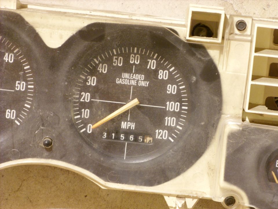 Dashboard gauge cluster with speedometer, fuel gauge, and odometer showing 31565. The speedometer reads up to 120 MPH